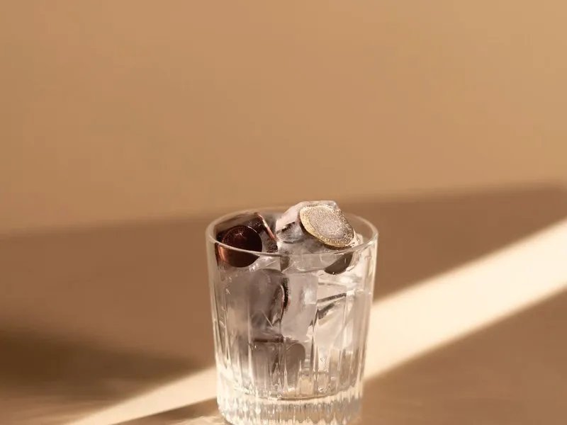 Coins in a small glass in warm light